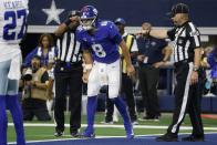 New York Giants quarterback Daniel Jones (8) attempts to walk off the field after suffering an unknown injury running the ball in the first half of an NFL football game against the Dallas Cowboys in Arlington, Texas, Sunday, Oct. 10, 2021. (AP Photo/Michael Ainsworth)