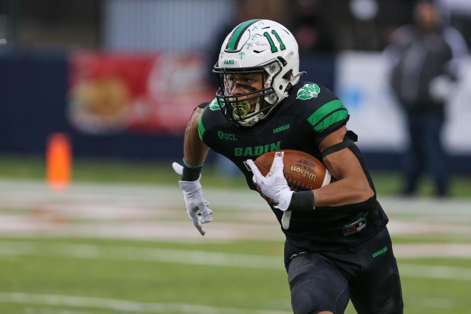 Badin's Braedyn Moore takes the ball down the field during the OHSAA Division III State Final game between the Badin Rams and The Chardon Hilltoppers at Tom Benson Hall of Fame Stadium on Friday Dec. 3, 2021. The game was tied 7-7 at halftime.