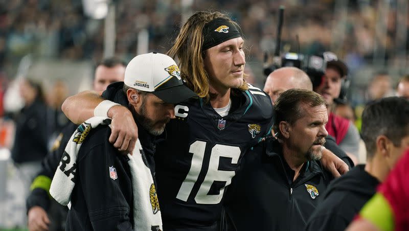 Jacksonville Jaguars quarterback Trevor Lawrence (16) is assisted off the field after he was injured during the second half of an NFL football game against the Cincinnati Bengals, Monday, Dec. 4, 2023, in Jacksonville, Fla.