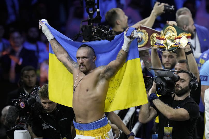 Ukraine's Oleksandr Usyk celebrates after beating Britain's Anthony Joshua to retain his world heavyweight title at King Abdullah Sports City in Jeddah, August 2022