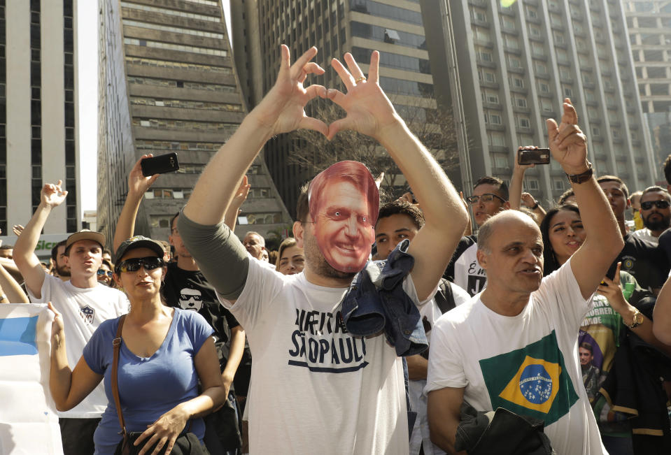 Supporters of Jair Bolsonaro, a presidential candidate who survived being stabbed during a campaign event days ago, march along Paulista Avenue to show support for the National Social Liberal Party candidate in Sao Paulo, Brazil, Sunday, Sept. 9, 2018. Brazil will hold general elections on Oct. 7. (AP Photo/Andre Penner)