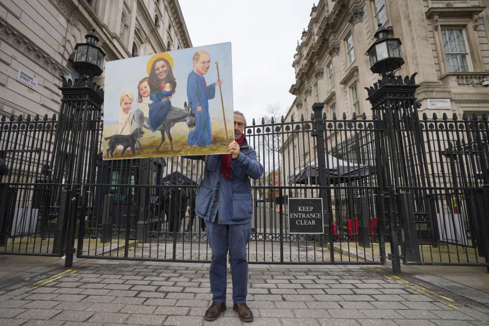 Artist Kaya Mar holds his painting of Britain's Prince and Princess of Wales outside Downing Street in London, Wednesday, March 20, 2024. A British privacy watchdog is looking into a report that staff at a private London hospital tried to snoop on the Princess of Wales' medical records while she was a patient for abdominal surgery. The Information Commissioner's Office said: "We can confirm that we have received a breach report and are assessing the information provided." (AP Photo/Kirsty Wigglesworth)