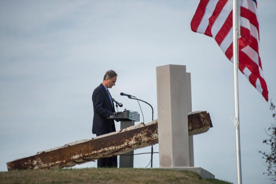 Alex Crowley talks about the Sept. 11, 2001, terrorist attacks during the 9 / 11 memorial service at Bloomington’s Ivy Tech Community College in 2017. He is standing next to a piece of a beam from the collapsed World Trade Center in New York City.