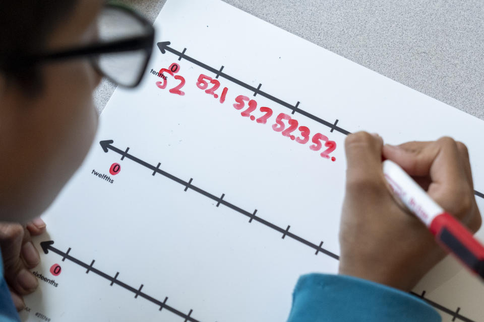 A fifth grade student attends a math lesson during class at Mount Vernon Community School, in Alexandria, Va., Wednesday, May 1, 2024. (AP Photo/Jacquelyn Martin)