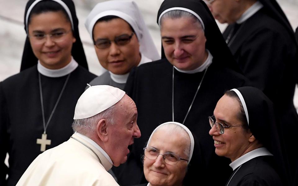 Pope Francis joking with nuns during a general audience at the Vatican - Shutterstock