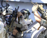 Special forces operators hold their weapons during a joint U.S.-Cyprus military drill at Limassol port on Friday, Sept. 10, 2021. Cyprus' Defense Minister Charalambos Petrides said the U.S. and Cyprus are on the same strategic path to ensure security and stability in a turbulent region and that continued close cooperation between the special forces of both countries aim to counter threats from potential terrorist acts. (AP Photo/Philippos Christou)