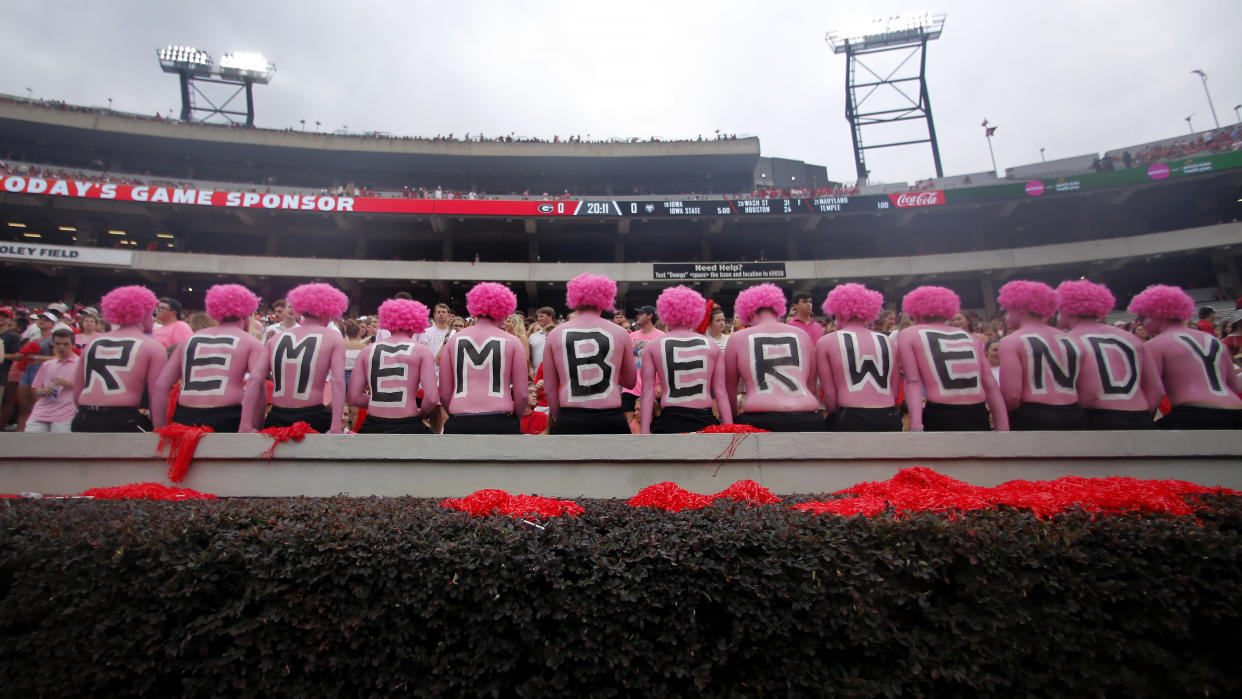 Georgia fans observe a moment of silence in horror of Wendy Anderson, wife of Arkansas State head coach Blake Anderson before an NCAA college football game Saturday, Sept. 14, 2019, in Athens, Ga. Fans were encouraged to "pink out" the stadium for Wendy Anderson who died from breast cancer in August. (AP Photo/John Bazemore)