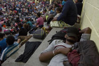 Honduran migrants rest at an improvised shelter in Chiquimula, Guatemala, Tuesday, Oct. 16, 2018. U.S. President Donald Trump threatened on Tuesday to cut aid to Honduras if it doesn't stop the impromptu caravan of migrants, but it remains unclear if governments in the region can summon the political will to physically halt the determined border-crossers. (AP Photo/Moises Castillo)