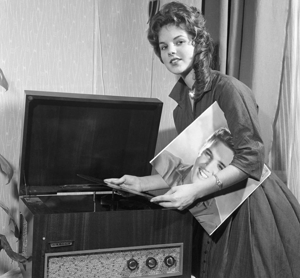 Priscilla Presley plays an Elvis album, 1960