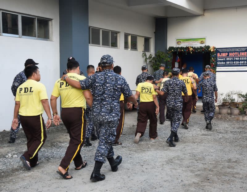 Some of the accused in the 2009 Maguindanao Massacre are escorted to attend the promulgation of the case, inside a prison facility in Taguig City