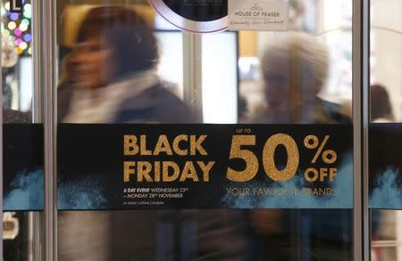 Shoppers walk through the entrance to a store promoting "Black Friday" in Oxford Street, London, Britain November 24, 2016. REUTERS/Peter Nicholls