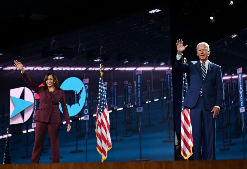 Senator from California and Democratic vice presidential nominee Kamala Harris and Former vice-president and Democratic presidential nominee Joe Biden wave from the stage socially distanced from each other at the end of the third day of the Democratic National Convention, being held virtually amid the novel coronavirus pandemic, at the Chase Center in Wilmington, Delaware on August 19, 2020. (Photo by Olivier DOULIERY / AFP) (Photo by OLIVIER DOULIERY/AFP via Getty Images)