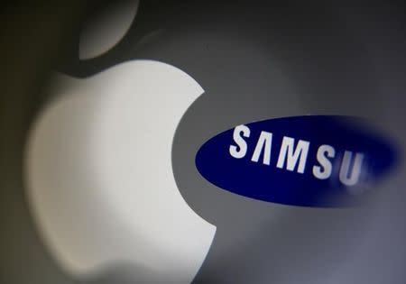 A Samsung logo and a logo of Apple are seen in this September 23, 2014 illustration photo in Sarajevo. REUTERS/Dado Ruvic