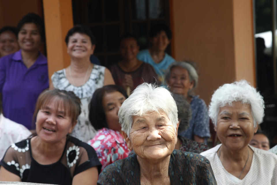 In this March 14, 2019, photo, Thai women listen as Veerawit Chuajunud, who changed his name to Thaksin Chuajunud of Pheu Chart party, introduces himself during an election campaign in Nakhon Ratchasima, Thailand. Thailand’s former Prime Minister Thaksin Shinawatra is in exile and banned from interfering in the country’s politics. But his name is a powerful political attraction and in tribute, and to win votes, some candidates in general election on Sunday, March 24, 2019 have changed their names to Thaksin so supporters of the former leader can register their loyalty at the ballot box. (AP Photo/Sakchai Lalit)