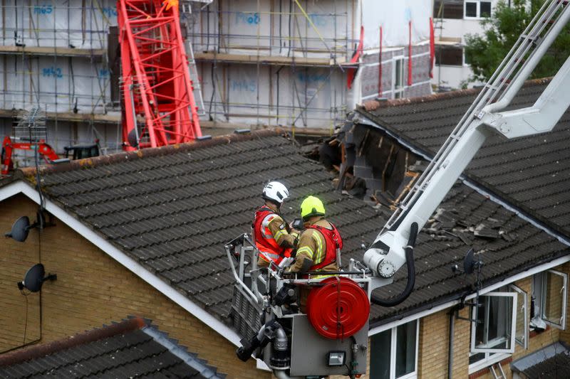 Rescue personnel work at the area where a crane collapsed in Bow, east London