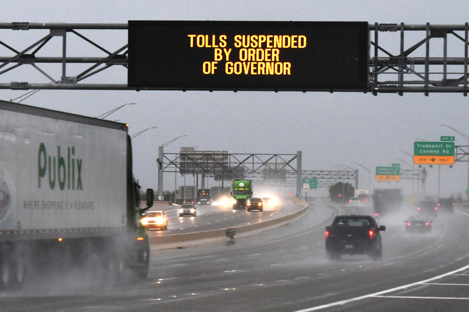 A sign on State Road 528 in Orlando advises drivers that tolls have been suspended as Hurricane Ian approaches on Sept. 28, 2022.