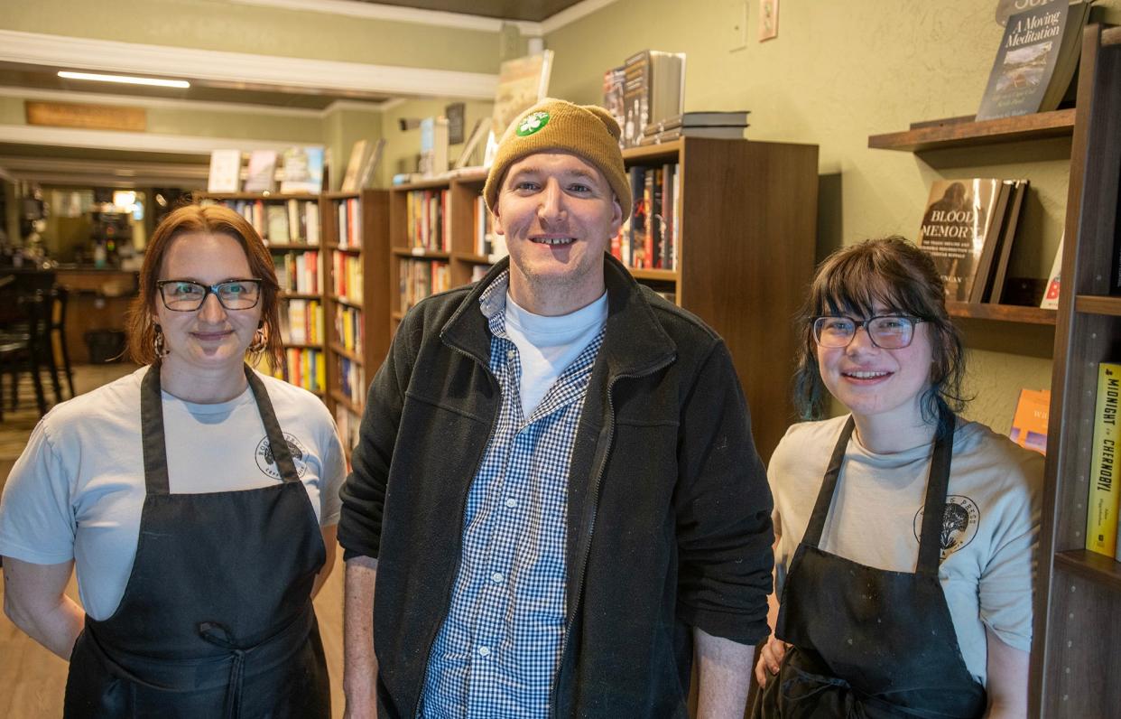 Root and Press owner Rich Collins is joined by Monica Kristan, left, and Maddy Babowitch at the café's new location.