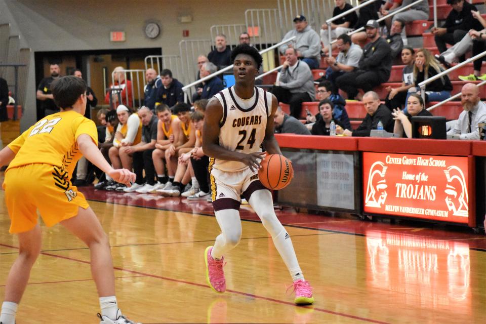 Bloomington North's JQ Roberts (24) prepares to shoot a three during the Cougars' sectional matchup with Mooresville on Feb. 28, 2023.