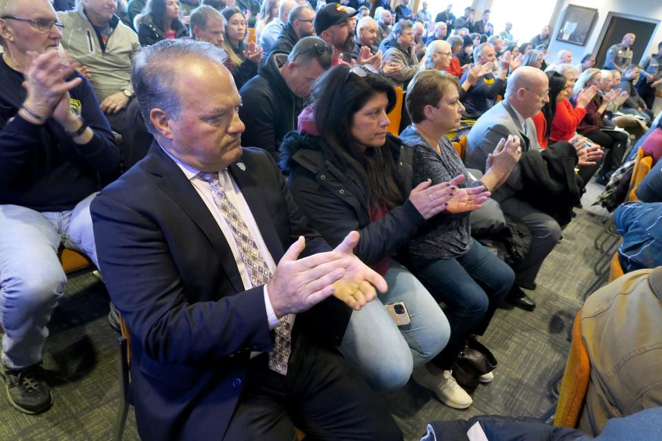 Toms River Police Chief Mitch Little applauds after an audience member commented during the Toms River Council meeting Wednesday, February 14, 2024, where an ordinance which cuts two captains' jobs and one patrol officer was being considered. Mayor Dan Rodrick said he has already eliminated the need for the council to vote on the ordinance by already making the changes in the department.