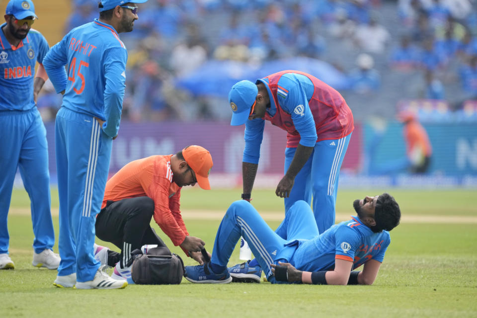 India's Hardik Pandya receives medical treatment after being injured during the ICC Men's Cricket World Cup match between India and Bangladesh in Pune, India, Thursday, Oct. 19, 2023. (AP Photo/Anupam Nath)