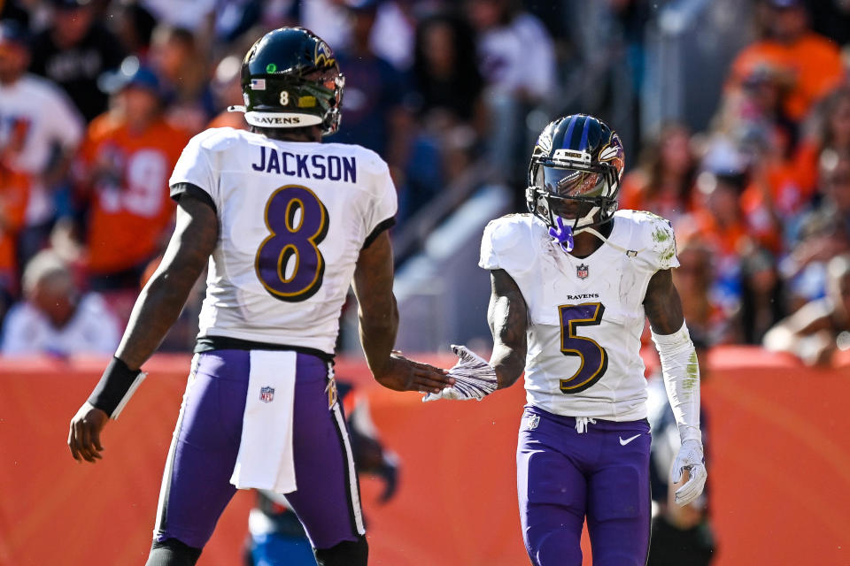 DENVER, CO - OCTOBER 3:  Lamar Jackson #8 and Marquise Brown #5 of the Baltimore Ravens celebrate after connecting for a second quarter touchdown against the Denver Broncos at Empower Field at Mile High on October 3, 2021 in Denver, Colorado. (Photo by Dustin Bradford/Getty Images)