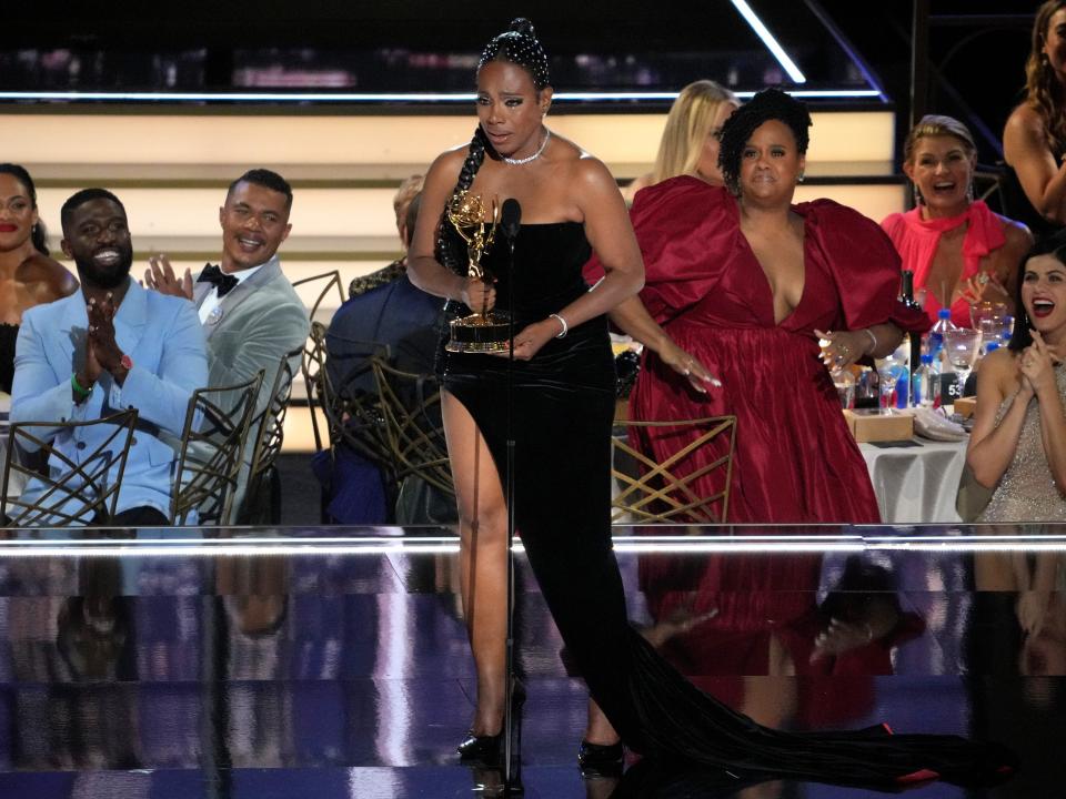 Sheryl Lee Ralph in black gown with slit accepting emmy award on stage
