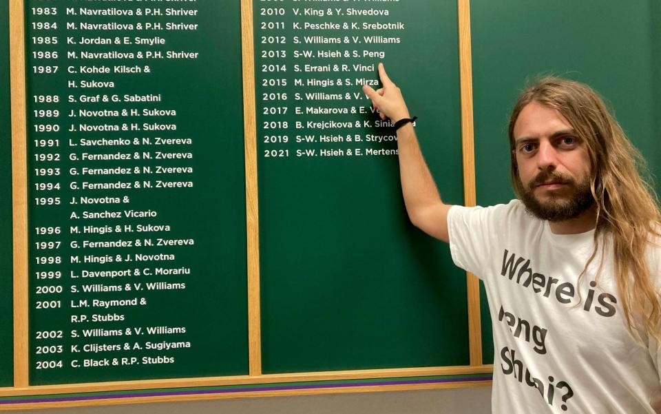 Protesters (left to right) Jason Leith, 34, who all work for Free Tibet in front of the Wimbledon honours board, Jason has come to Wimbledon to draw attention to Peng Shuai. Picture date: Monday July 4, 2022 - Rebecca Speare-Cole/PA