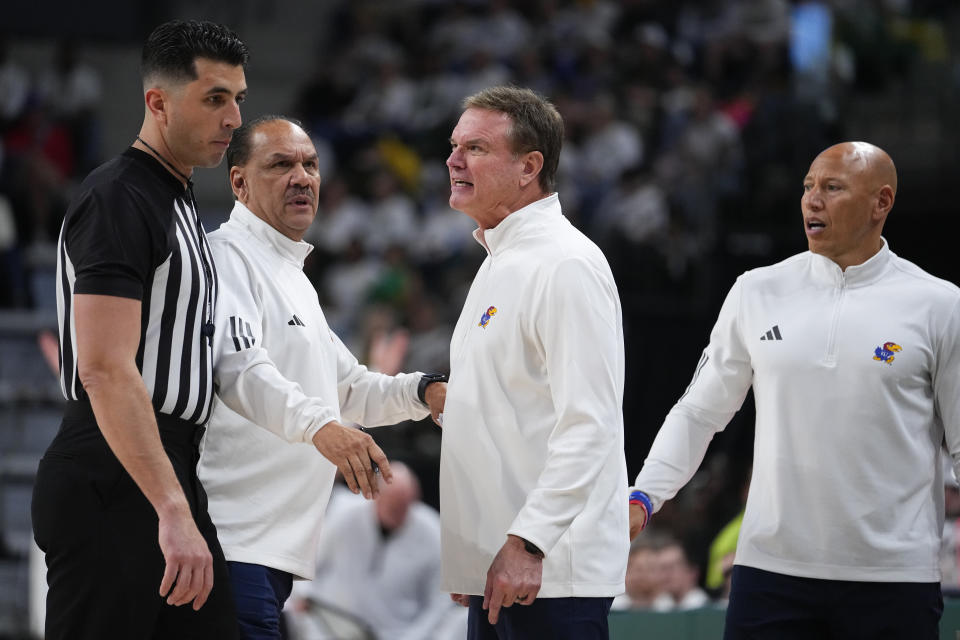 Kansas head coach Bill Self, center, reacts while talking to referee Chris Pacsi, left, as assistant coaches Kurtis Townsend, second from left, and Fred Quartlebaum, right, look on after a play against Baylor during the first half of an NCAA college basketball game, Saturday, March 2, 2024, in Waco, Texas. (AP Photo/Julio Cortez)