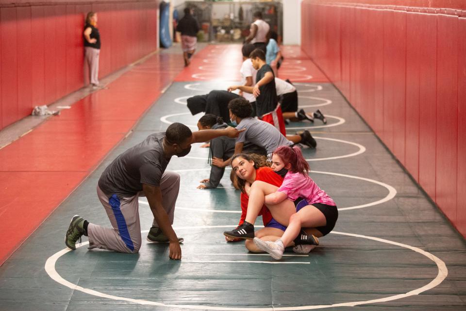 Floor mats line the wrestling room within Highland Park as students learn wrestling techniques during a practice last week. The program took a year off due to the district canceling the season last year but returns this year with determination and a few familiar faces.