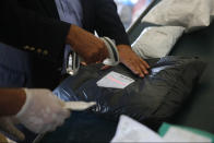 Palestinian postal workers process eight years' worth of undelivered mail held by Israel, at the post office in the West Bank city of Jericho, Sunday, Aug. 19, 2018. In recent days the postal staff has been sorting through tons of undelivered mail in a room packed with letters, boxes and even a wheelchair. Postal official Ramadan Ghazawi says Israel did not respect a 2008 agreement to send and receive mail directly through Jordan. Israeli officials say the one-time release of 10.5 tons of mail was a "gesture." (AP Photo/Nasser Shiyoukhi)