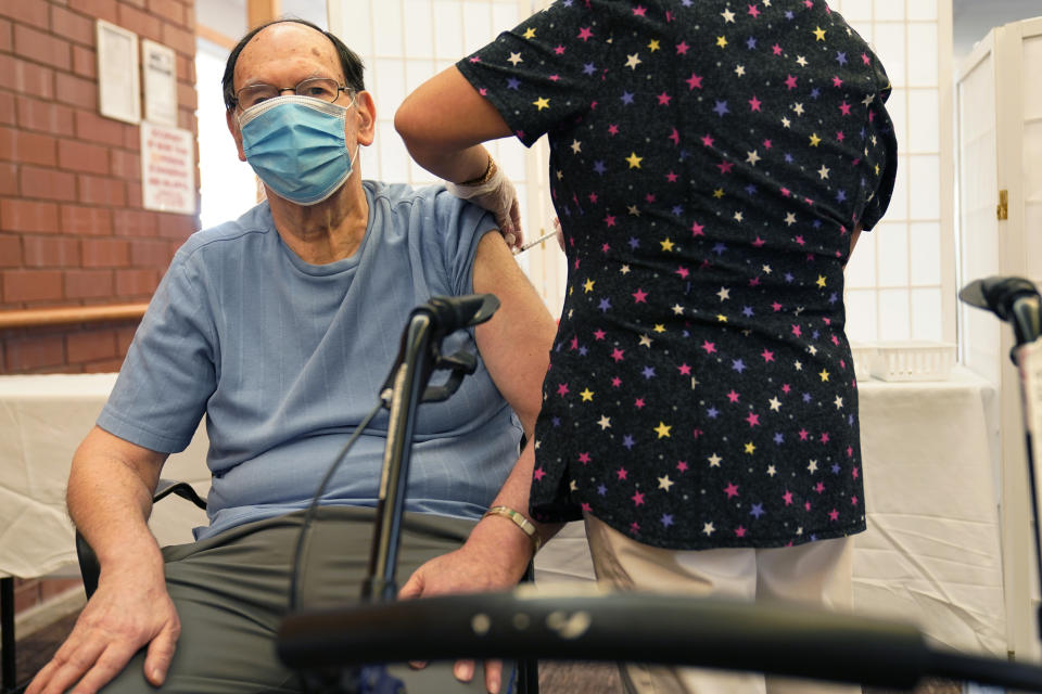 Marvin Marcus, 79, a resident at the Hebrew Home at Riverdale, receives a COVID-19 booster shot in New York, Monday, Sept. 27, 2021. The deadline for hospital and nursing home workers in New York state to be vaccinated against COVID-19 arrived Monday with the prospect of severe staff shortages fueled by workers getting suspended or fired for refusing to be inoculated. All health care workers in New York state at hospitals and nursing homes are required to be vaccinated with at least one dose of the COVID-19 vaccine by Monday. (AP Photo/Seth Wenig)