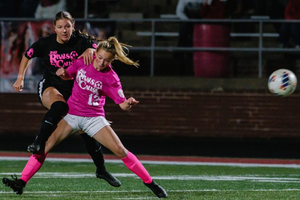 New Phila's Allie Baker kicks around the steal attempt by Dover's Emilyn Feller, Saturday, Oct. 15 at Crater Stadium.