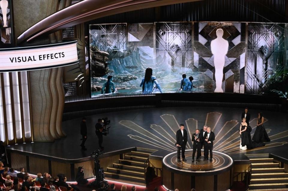 Richard Baneham accepts the Oscar for Best Visual Effects for "Avatar: The Way of Water" onstage