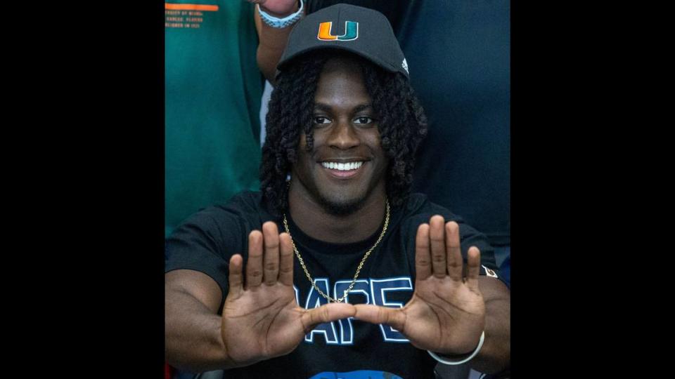 Damari Brown, flashes the sign of the U after deciding to sign with the University of Miami.