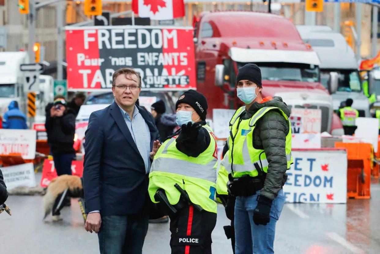 Alberta lawyer Keith Wilson, left, was a common sight during the winter 2022 convoy protests in the nation's capital. According to a document obtained by Radio-Canada, that province's law society has dismissed a complaint made about Wilson's conduct during the weeks-long demonstrations. (Patrick Doyle/Reuters - image credit)