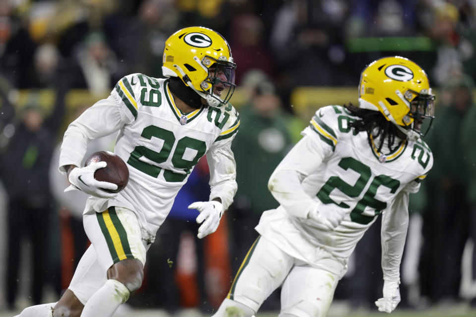 Green Bay Packers cornerback Rasul Douglas (29) returns a Tennessee Titans quarterback Ryan Tannehill pass as cornerback Kristian Fulton (26) helps defend on the return during the second half of an NFL football game Thursday, Nov. 17, 2022, in Green Bay, Wis. (AP Photo/Matt Ludtke)