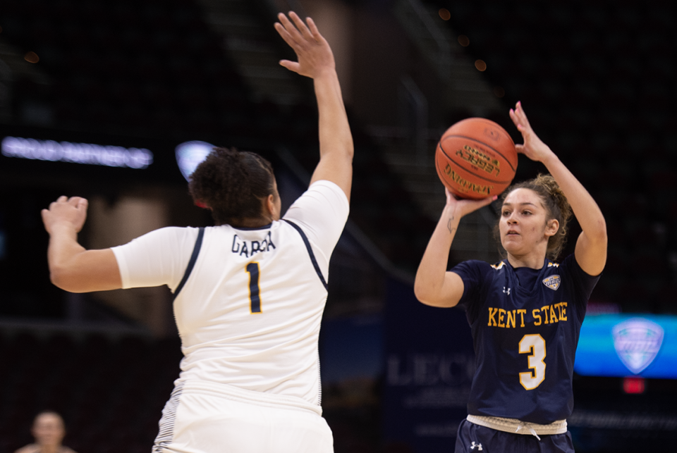 Corynne Hauser takes a shot, Nan Garcia on defense.