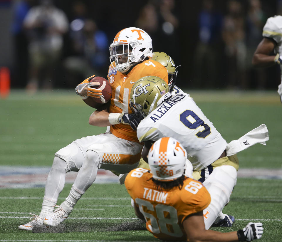 Tennessee running back John Kelly (4) is stopped by Georgia Tech linebacker Victor Alexander (9) in the first half of an NCAA college football game, Monday, Sept. 4, 2017, in Atlanta. (AP Photo/John Bazemore)