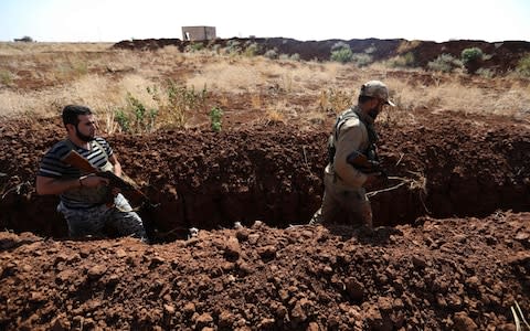 Syrian rebel fighters in Hama province, pictured on September 17 - Credit: OMAR HAJ KADOUR/AFP