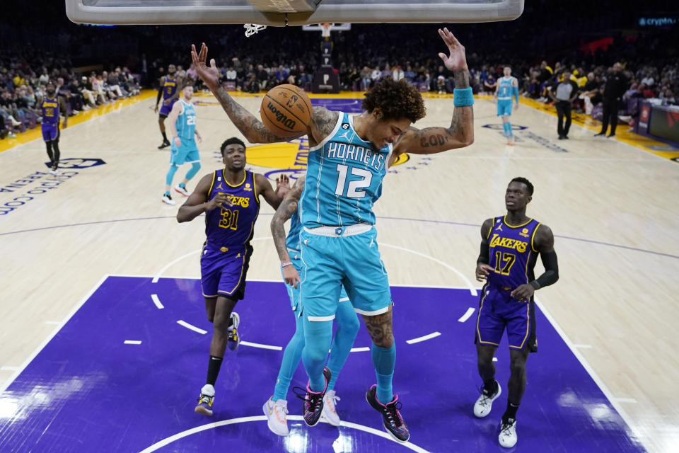 Charlotte Hornets guard Kelly Oubre Jr. (12) dunks against the Los Angeles Lakers during the first half of an NBA basketball game Friday, Dec. 23, 2022, in Los Angeles. (AP Photo/Marcio Jose Sanchez)