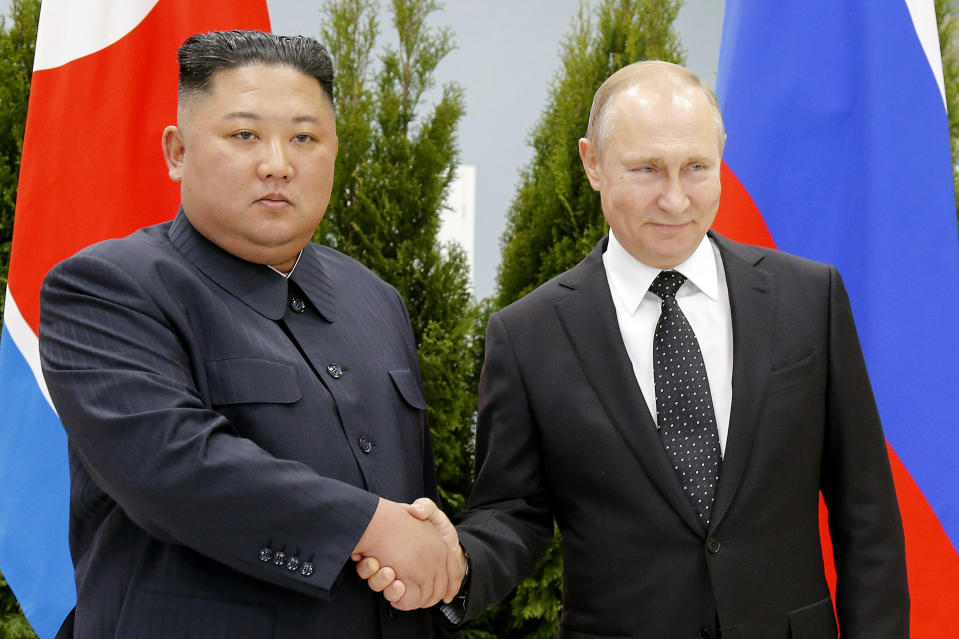 FILE - In this April 25, 2019 file photo, Russian President Vladimir Putin, right, and North Korea's leader Kim Jong Un shake hands during their meeting in Vladivostok, Russia. From nukes to huge food aid shipments to a shared skepticism about the United States, Chinese President Xi Jinping and North Korean leader Kim will have a long list of topics to discuss when Xi heads north Thursday, June 20.(AP Photo/Alexander Zemlianichenko, Pool, File)