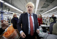 Britain's Prime Minister Boris Johnson visits John Smedley Mill in Matlock, England, Thursday, Dec. 5, 2019. Britain is holding a general election a week from now and fractures are emerging within jittery political parties unsure how a volatile electorate will judge them. Conservative Prime Minister Boris Johnson and main opposition Labour Party leader Jeremy Corbyn both faced criticism of their moral character. (Hannah McKay/Pool Photo via AP)