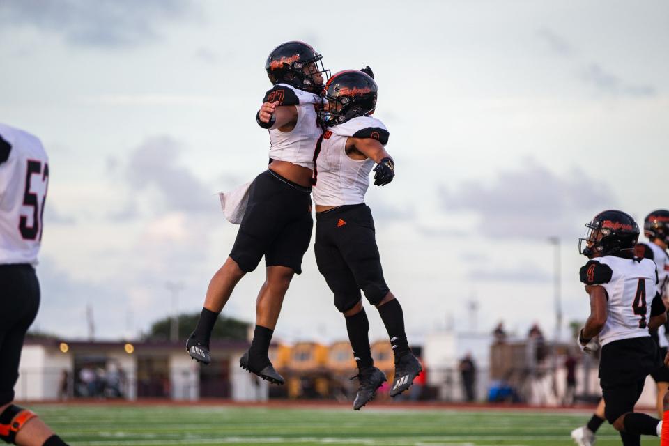 Refugio's Kaleb Brown (9) and Jordan King (27) celebrate after a touchdown from Brown during a high school football game against London at Hornet Stadium in Corpus Christi, Texas on Friday, Sep. 2, 2022.