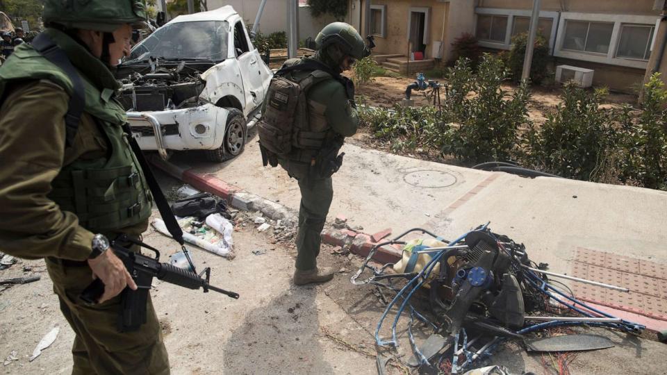 PHOTO: Israeli soldiers stand by an engine from a hang glider that Palestinian militants used a few days earlier in an attack on this kibbutz near the border with Gaza, in Kfar Gaza, Israel, Oct. 10, 2023. (Amir Levy/Getty Images)