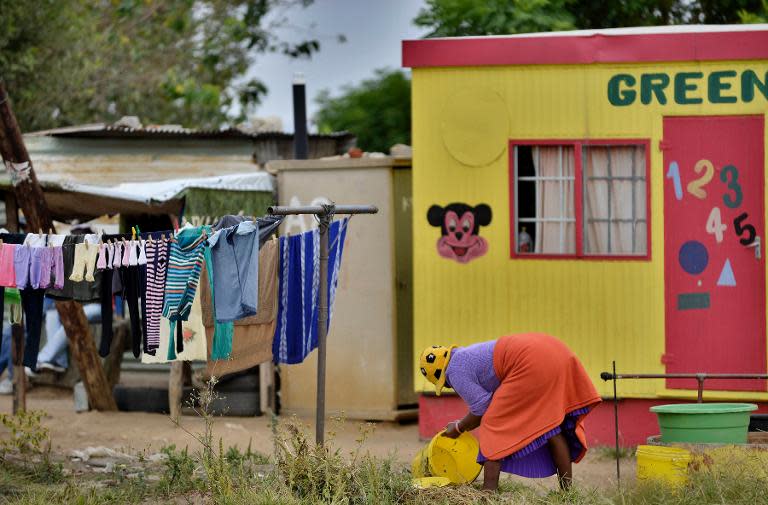 A woman tends to her laundry in the impoverished Diepsloot township outside Johannesburg on April 16, 2014