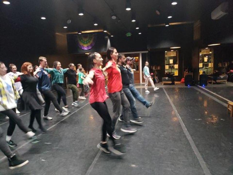 Rania Charalambidou leads guests in learning the Hasapiko during free Greek folk dance lessons at Montgomery Ballet.