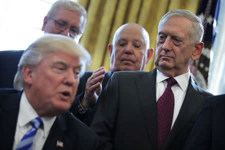 FILE PHOTO: U.S. Defense Secretary James Mattis looks at U.S. President Donald Trump as he speaks during a meeting with Medal of Honor recipients in the Oval Office of the White House in Washington, U.S., March 24, 2017. REUTERS/Carlos Barria/File Photo