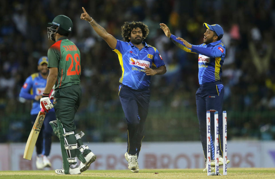 Sri Lanka's bowler Lasith Malinga, center, celebrates the wicket of Bangladeshi batsman Tamim Iqbal, left, during the first one-day international cricket match between Sri Lanka and Bangladesh in Colombo, Sri Lanka, Friday, July 26, 2019. (AP Photo/Eranga Jayawardena)