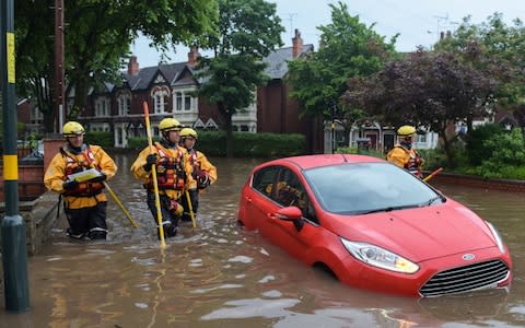 Residents on Sir Johns Road in Selly Oak, Birmingham had to be rescued by firefighters using boats - Credit: Michael Scott/Caters News