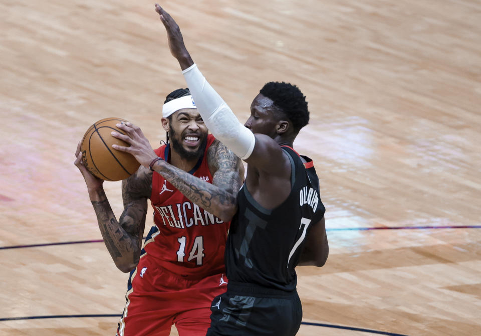 New Orleans Pelicans forward Brandon Ingram (14) is defended by Houston Rockets guard Victor Oladipo (7) during the third quarter of an NBA basketball game in New Orleans, Saturday, Jan. 30, 2021. (AP Photo/Derick Hingle)